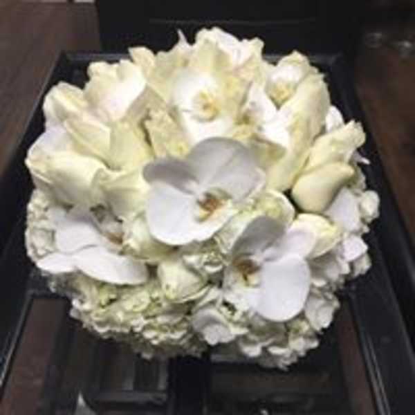 White orchid and hydrangea bouquet in a dark box