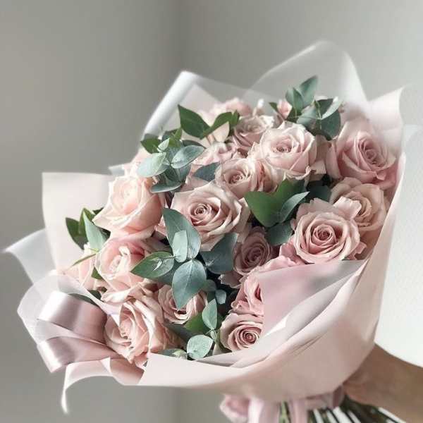 Bouquet of pale pink roses wrapped in blush paper