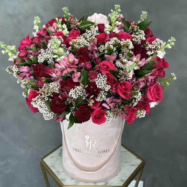 Pink and red rose bouquet in a blush hatbox