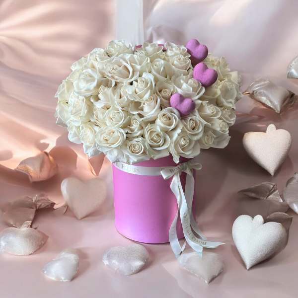 White rose bouquet in a pink hat box with heart decorations