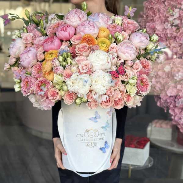 Large pastel bouquet of pink and white flowers in a white box