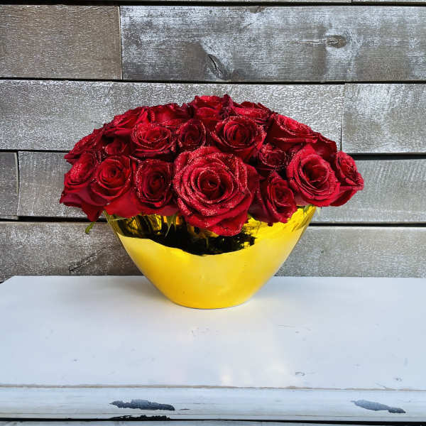 Red roses arranged in a yellow vase