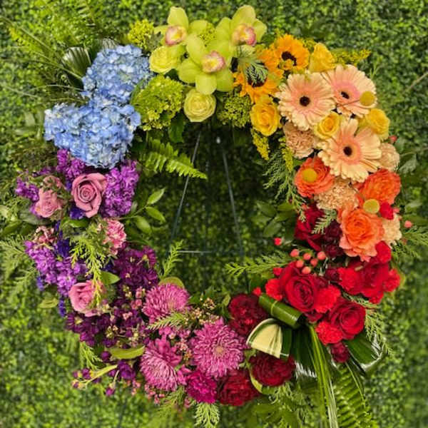 Rainbow floral wreath with roses, hydrangeas, and gerbera daisies