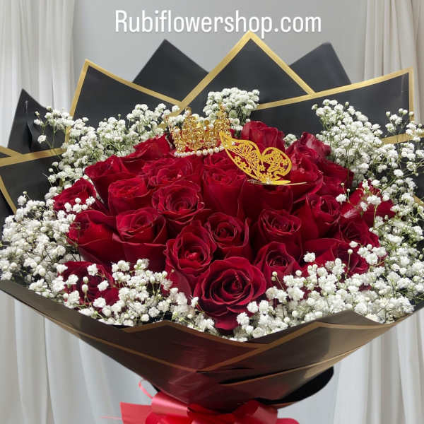 Bouquet of red roses with white baby's breath and a pink ribbon