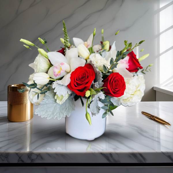 Bouquet of red roses and white orchids in a white vase