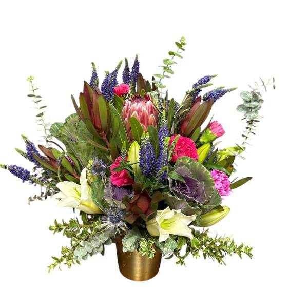 Mixed bouquet with purple, pink, and white flowers in a gold vase
