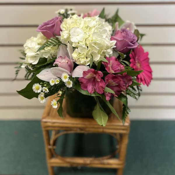 Bouquet of pink and white flowers in a dark vase