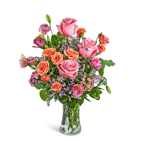 Pink and orange roses in a clear glass vase