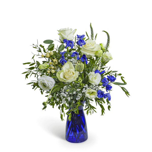 White roses and blue flowers in a cobalt glass vase