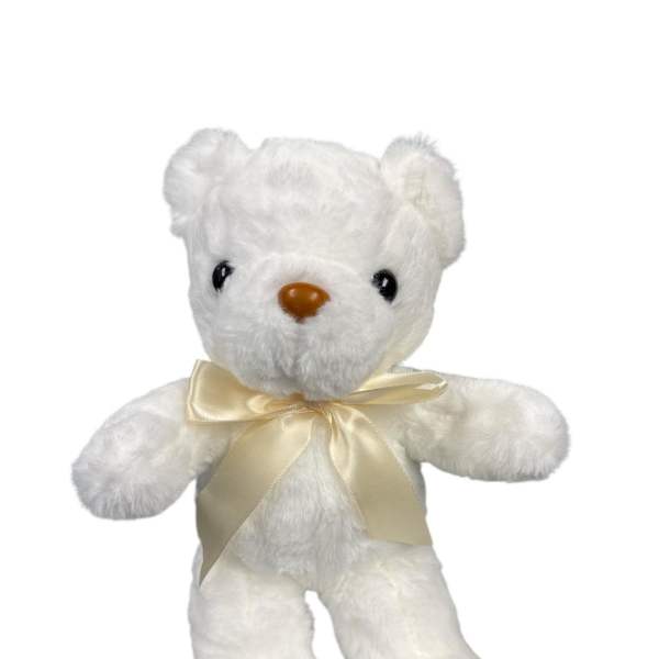 White teddy bear with a cream ribbon bow
