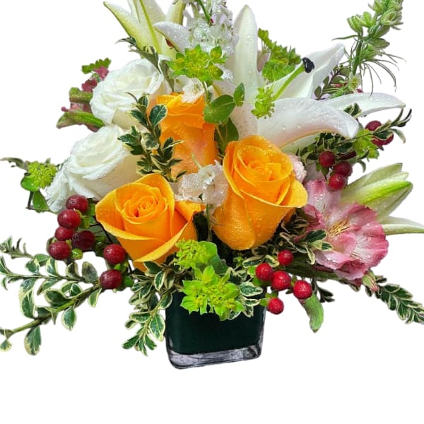 Orange roses and white lilies in a black vase with red berries
