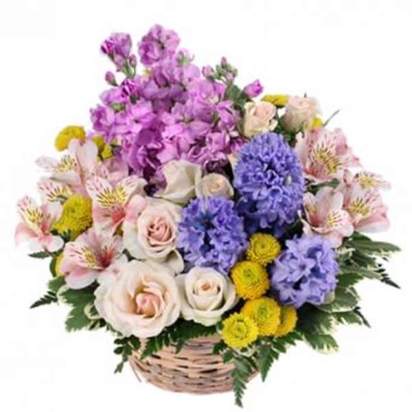 Basket arrangement of pink, purple, and yellow flowers