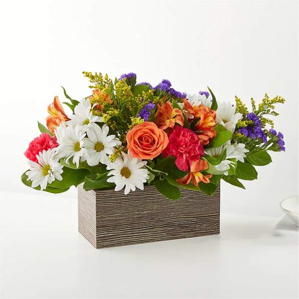 Mixed bouquet with roses, daisies, carnations, and purple filler in a rectangular box