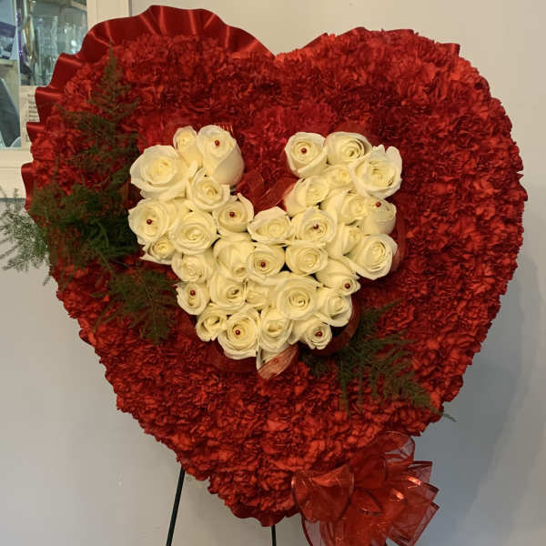 Heart-shaped red floral standing arrangement with white roses