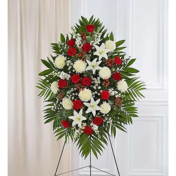Standing floral spray with red roses, white lilies, and white pompons