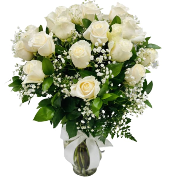 White rose bouquet in a glass vase with baby's breath