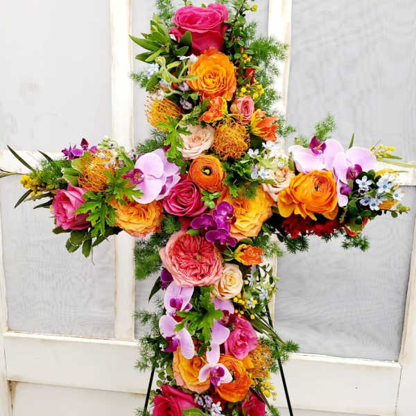 Cross-shaped floral standing spray with roses and orchids