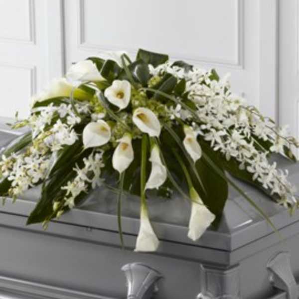 White floral casket spray with calla lilies and greenery