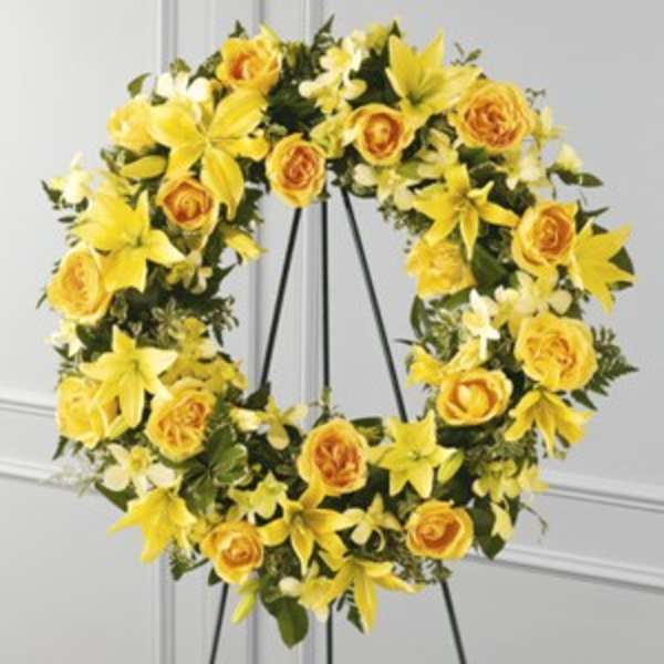Yellow floral wreath on a black easel stand