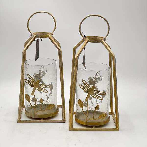 Two gold lanterns with glass cylinders and dragonfly accents