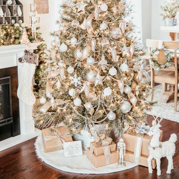 Decorated Christmas tree with gold and white ornaments and wrapped gifts
