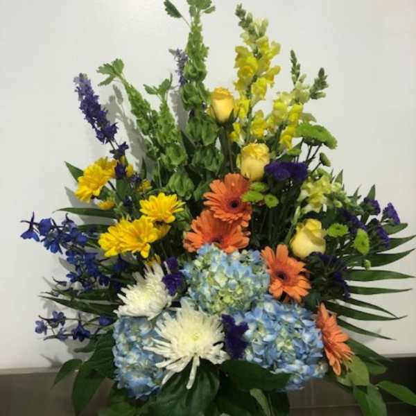 Colorful mixed flower arrangement in a white vase