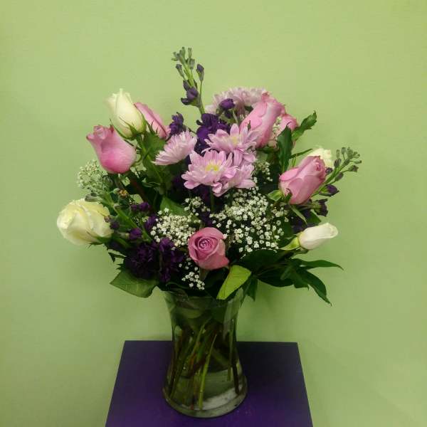 Mixed pink and white flowers in a clear glass vase
