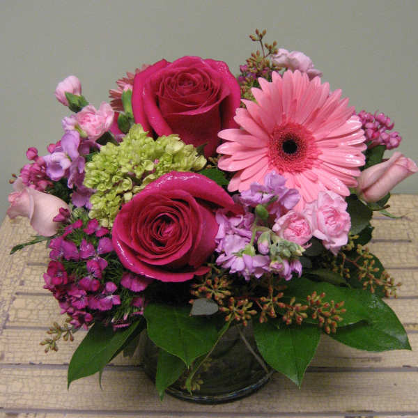 Pink and magenta flower arrangement in a glass vase