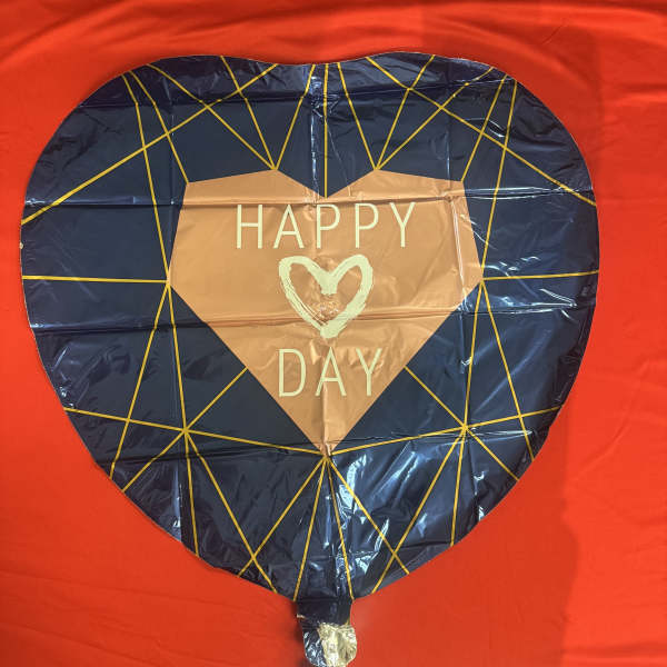 Heart-shaped balloon with "Happy Day" text on a red background