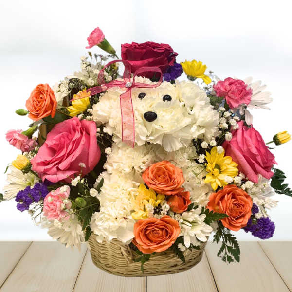 Basket arrangement with a teddy bear made of white flowers and colorful roses