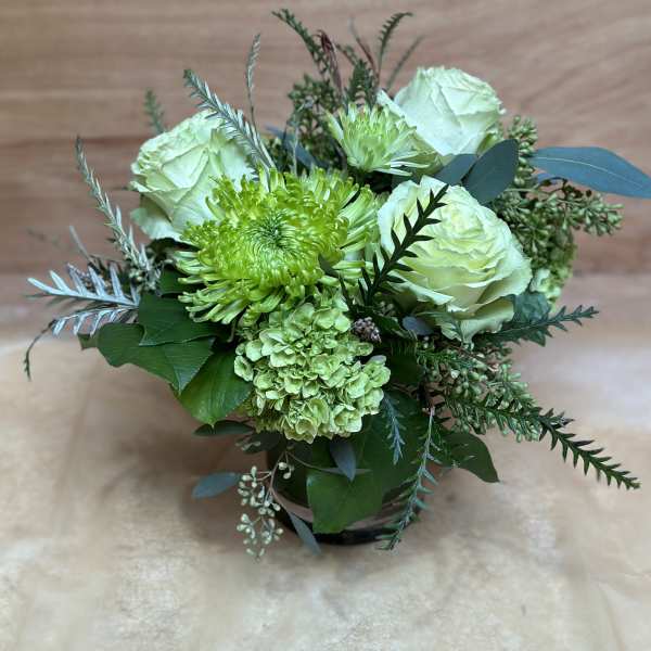 Green and white bouquet with roses and chrysanthemums in a vase