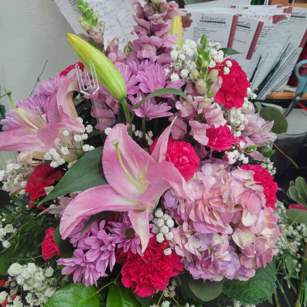 Pink lilies, hydrangeas, chrysanthemums, and carnations in a mixed bouquet