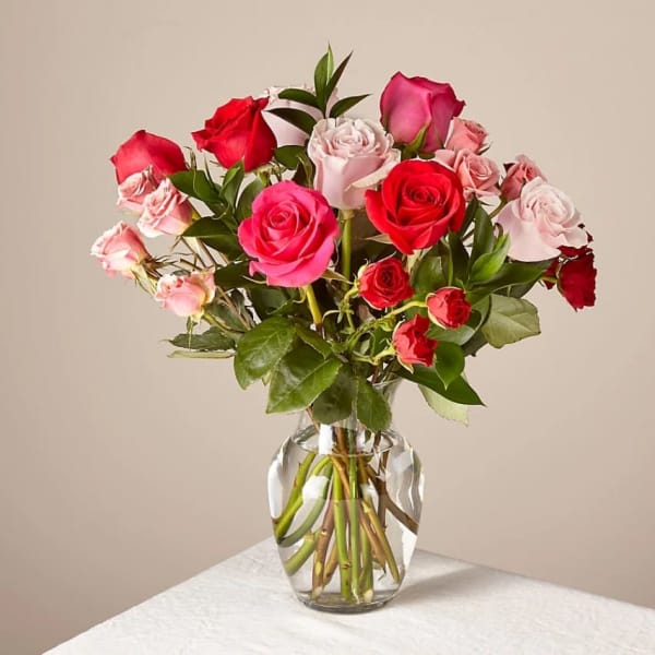 Bouquet of pink and red roses in a clear glass vase