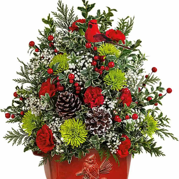 Christmas arrangement with red flowers, pinecones, and a red cardinal planter