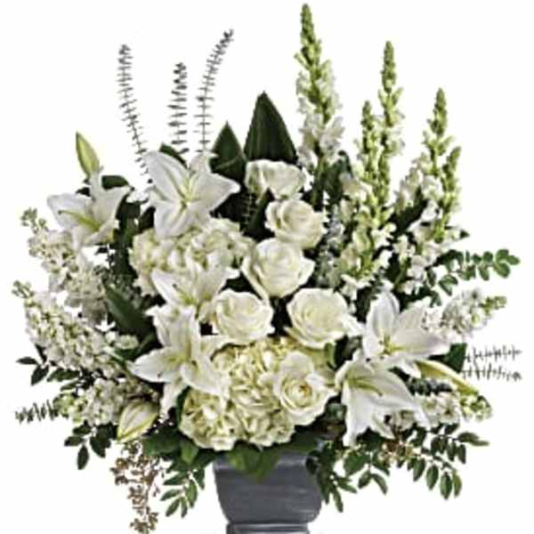White lilies and roses arranged in a gray vase