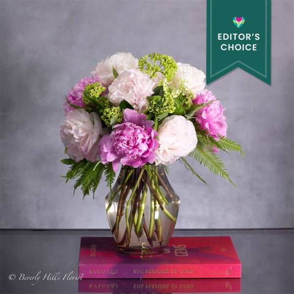 Pink and white floral arrangement in a glass vase