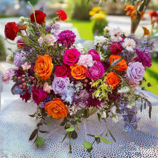 Colorful mixed bouquet of roses and other flowers on a table