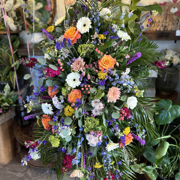 Large mixed flower spray with orange roses and white daisies