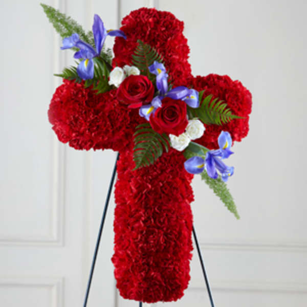 Red floral cross on a stand with blue and white accents