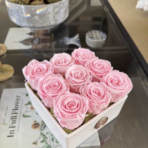 Pink roses arranged in a white square box