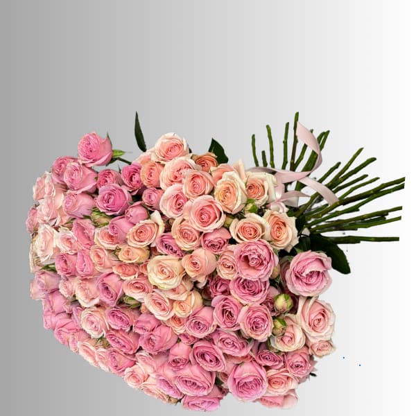 Large bouquet of pink and peach roses with a pale ribbon