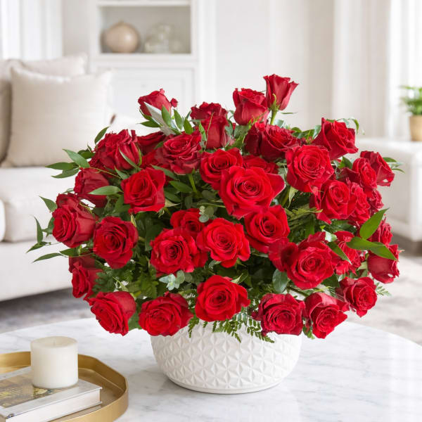 Large bouquet of red roses in a white textured vase