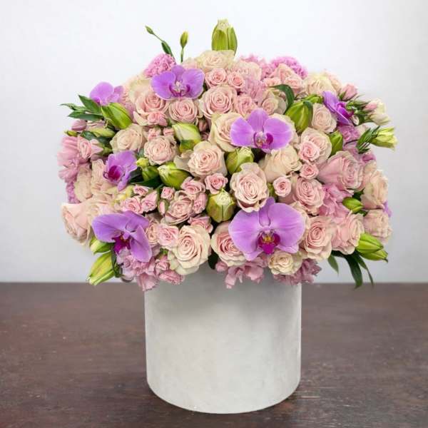 Pink rose and purple orchid arrangement in a white box
