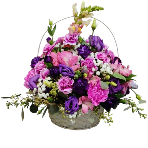 Basket arrangement of pink and purple flowers with white filler