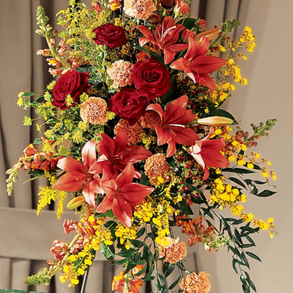 Tall floral spray with red lilies, roses, and yellow filler flowers