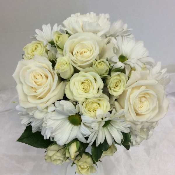 White roses and daisies arranged in a bouquet