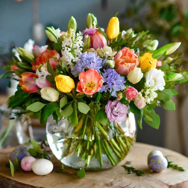 Colorful mixed tulip bouquet in a clear glass vase