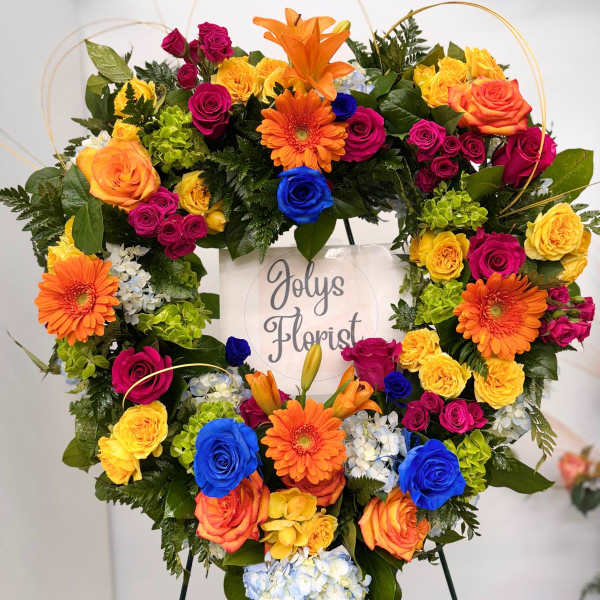 Heart-shaped floral wreath with multicolored roses and gerbera daisies