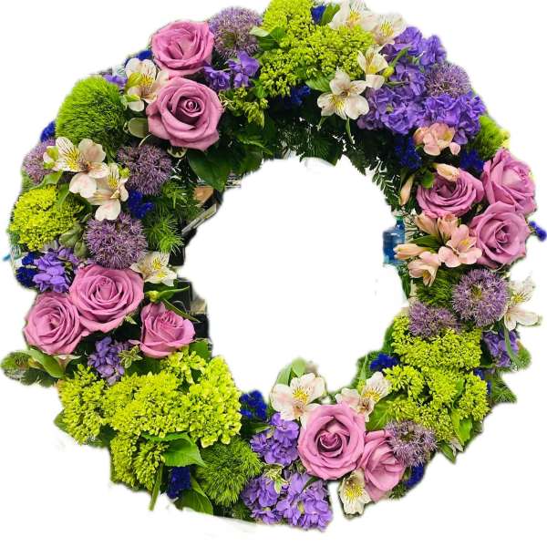 Circular floral wreath with pink roses, purple blooms, and bright green flowers