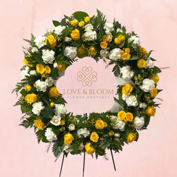 Yellow and white floral wreath on a pink background